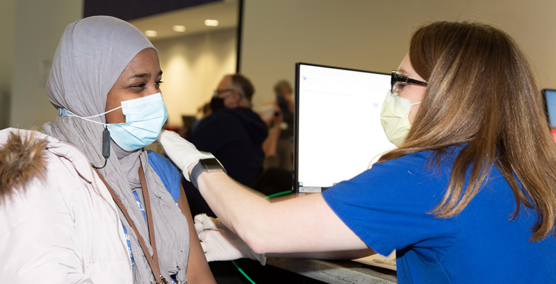 UK healthcare staff vaccinate the latest tier of recipients.